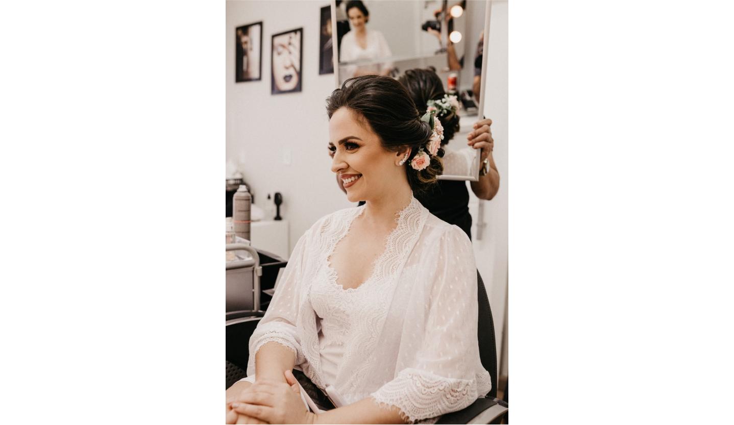 Bride getting her hair styled with floral accents at Salon Alure near Middleburg, VA