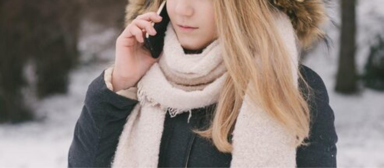 Woman outdoors in winter with scarf, healthy long hair protected from cold weather